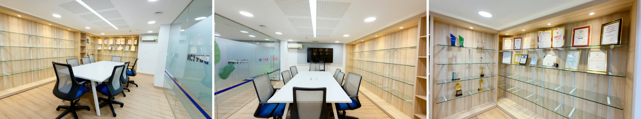Meeting room with glass partitions and corporate achievement display at Duy Tan Showroom