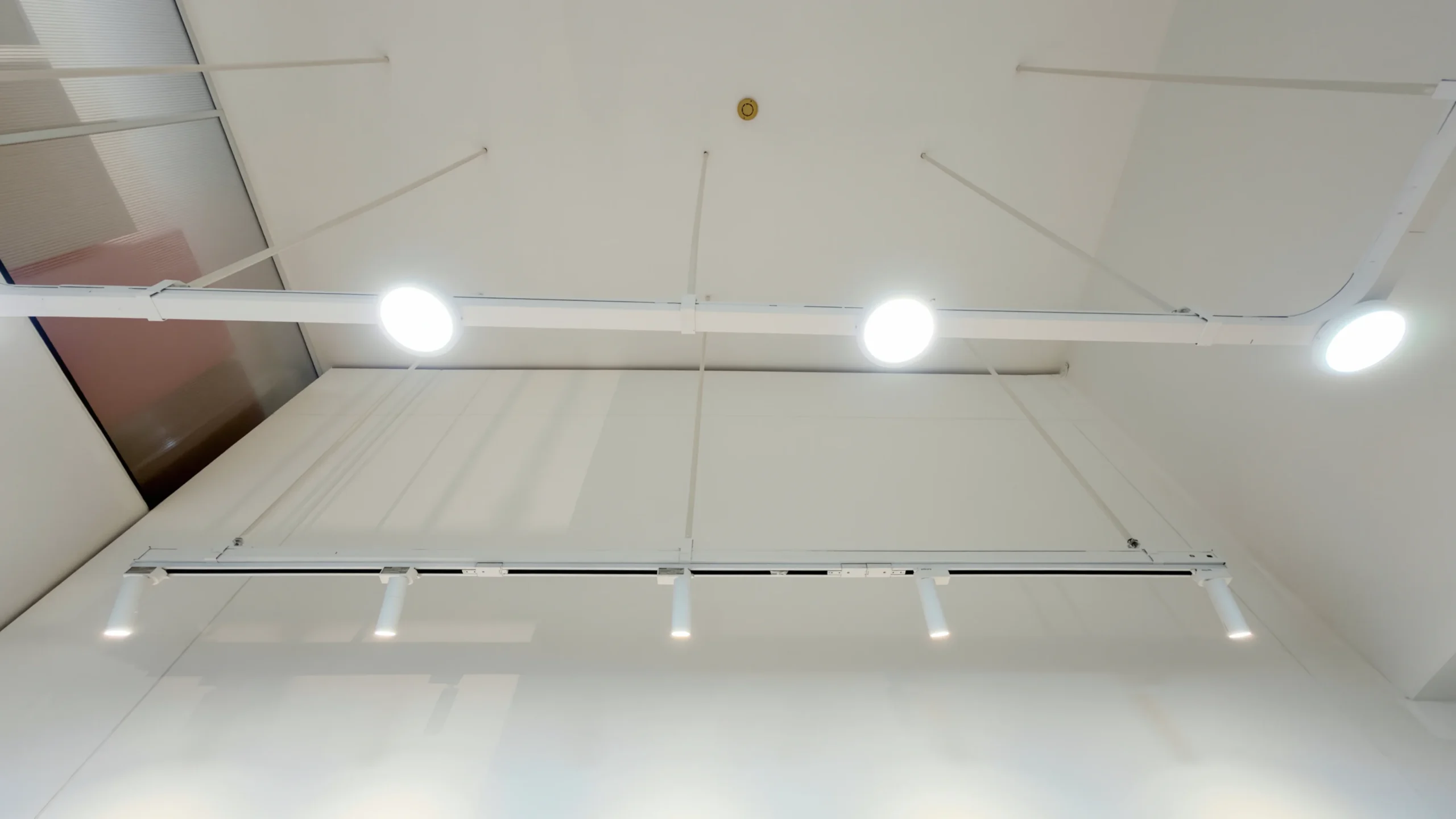 Retail lighting design with track lights downlights and integrated shelf lighting